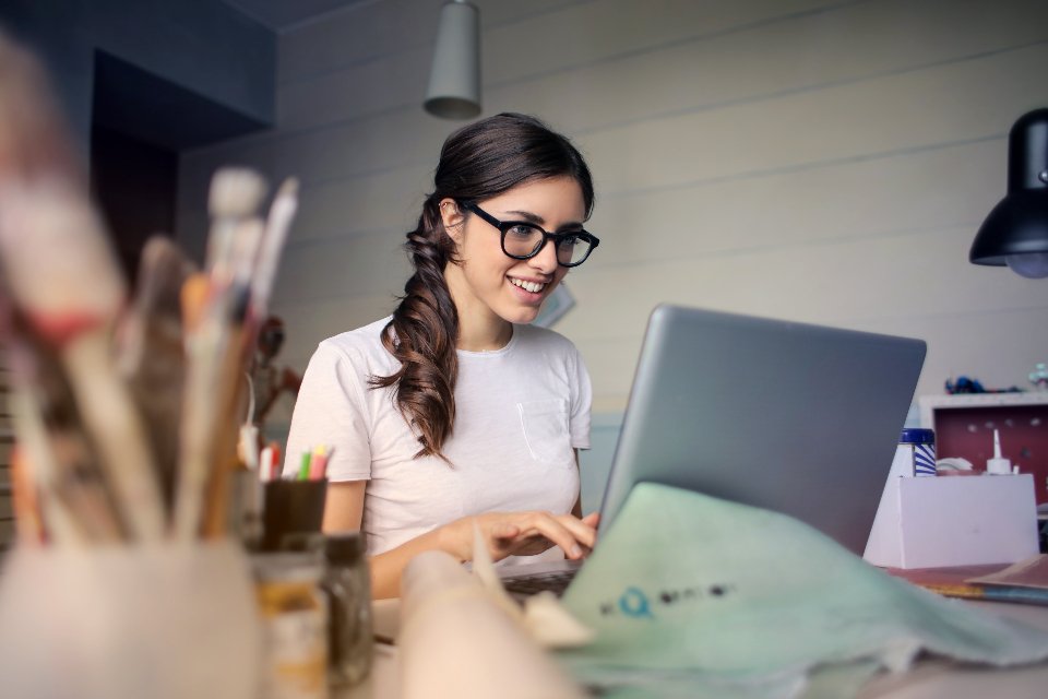 Professional reviewing project requirements on a laptop in a modern office