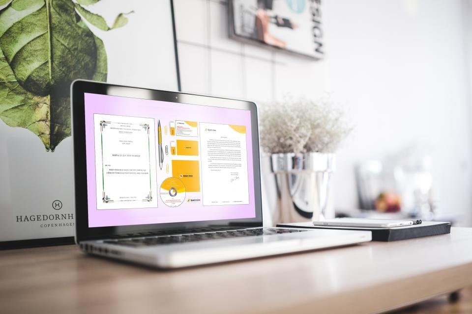Laptop displaying CRM reports and charts on an office desk