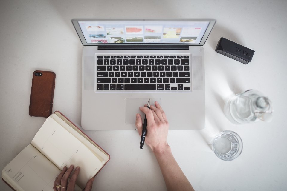 Implementation planning on a laptop with notes for a Salesforce project